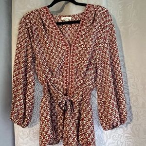 Red and tan patterned blouse